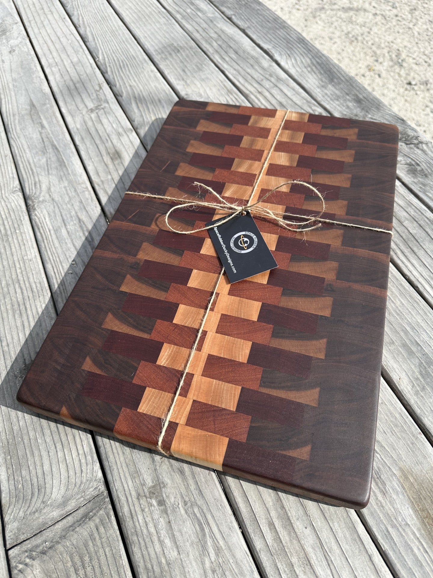 Handcrafted wood cutting board. Designed with black walnut, cherry, sapele, and maple hardwoods.