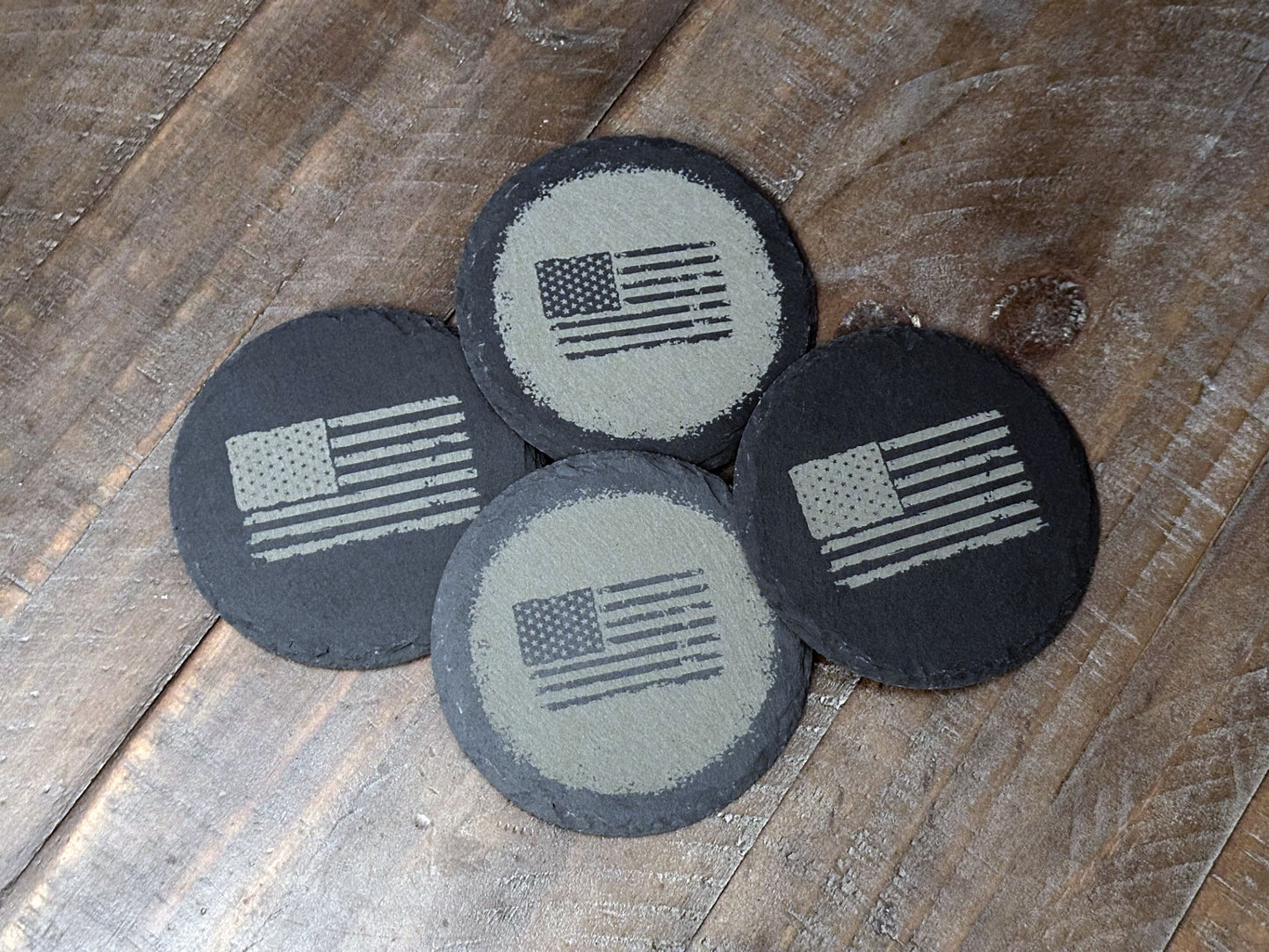 These USA themed slate coasters featured a US Flag design to show off that American pride. Laser engraved with either a light colored flag on a dark background or a dark colored flag on a light background, they’re a bold way to keep your drinks in check. Made from durable slate, these coasters are both functional and stylish, making them a perfect addition to any home or as a patriotic gift.