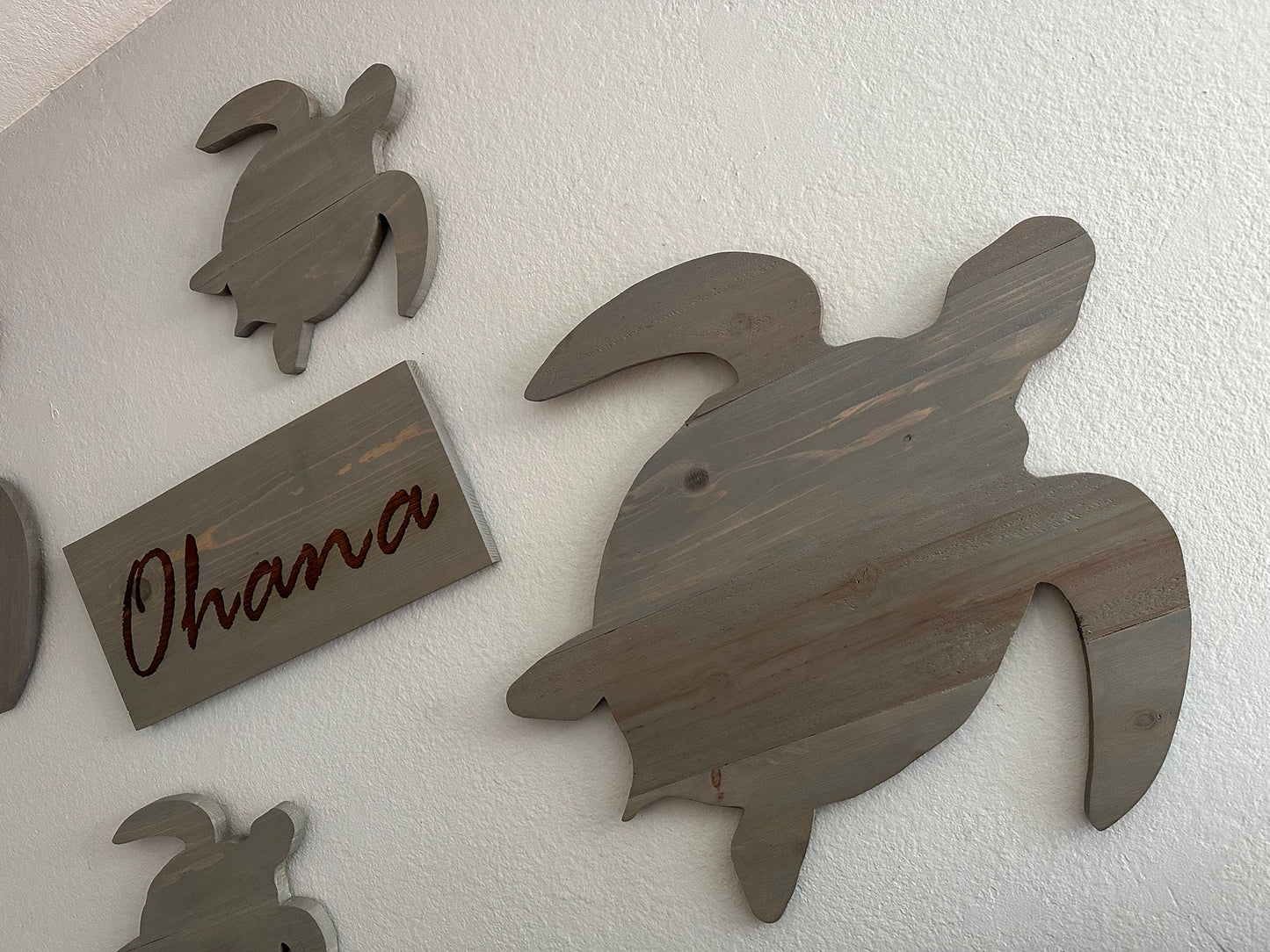 Custom handmade wood turtle wall art. Set of 4 turtles includes a board with Ohana laser engraved. Each piece includes mounting brackets and wall anchors.