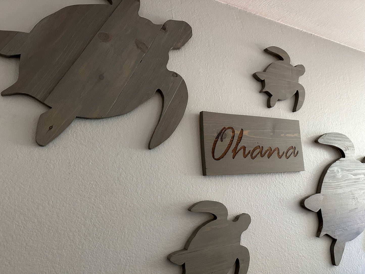 Custom handmade wood turtle wall art. Set of 4 turtles includes a board with Ohana laser engraved. Each piece includes mounting brackets and wall anchors.