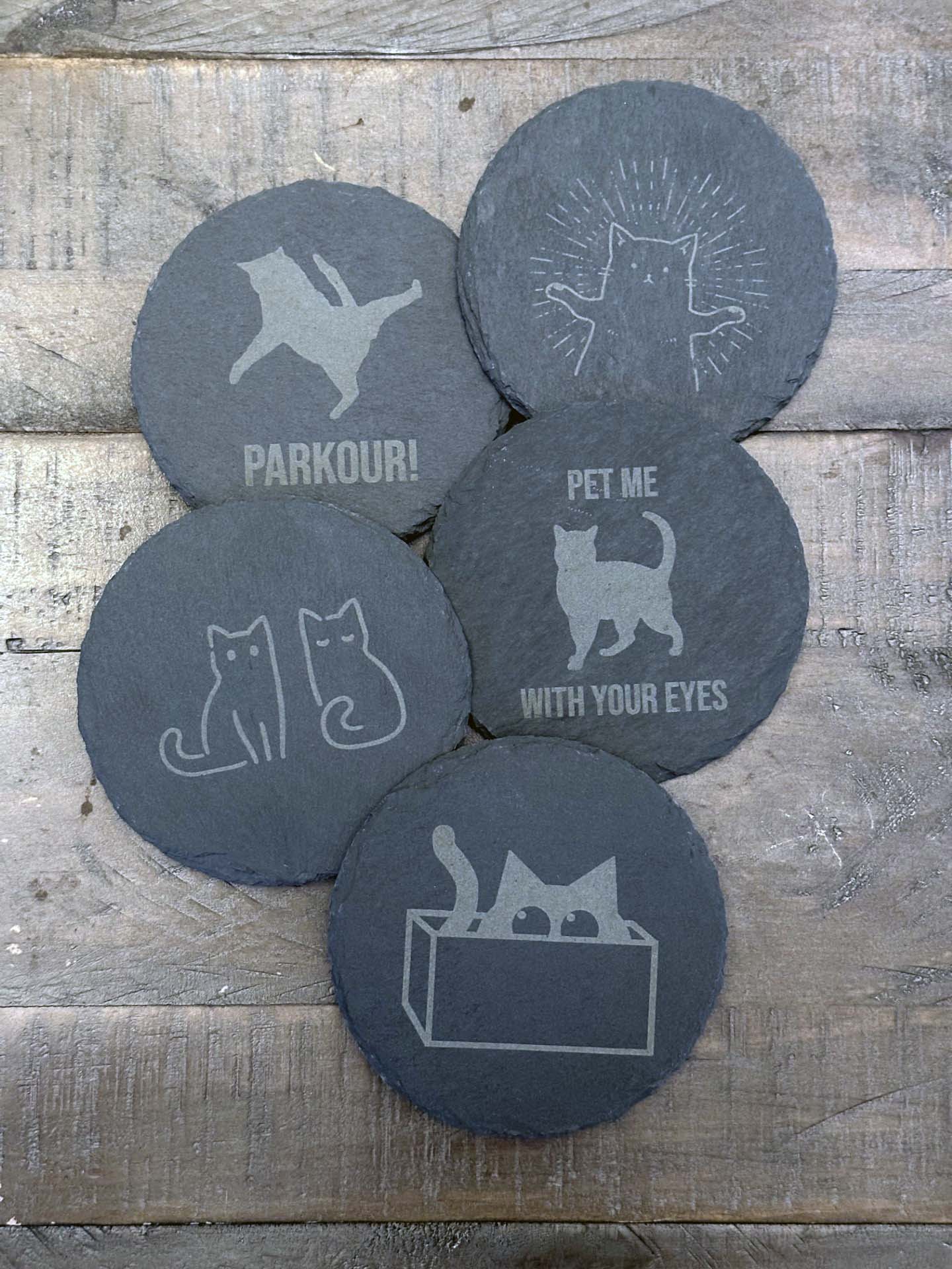 Add humor and style to your home with these laser engraved slate coasters with playful cat designs. The purfect gift, stocking stuffer or house warming gift.