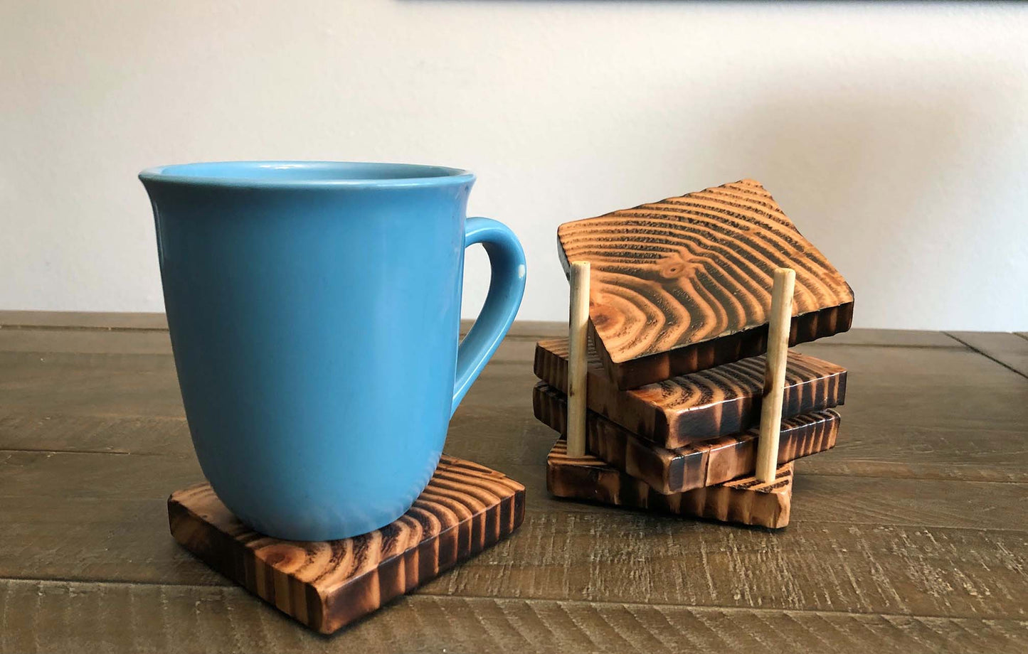 Rustic farmhouse wood coasters. Natural end grain pattern. Charred, burned and distressed. Patriotic red, white and blue distressed and burned. Set of 4 coasters and holder includes felt food pads. Handmade by Space Rubber Ducky Designs.