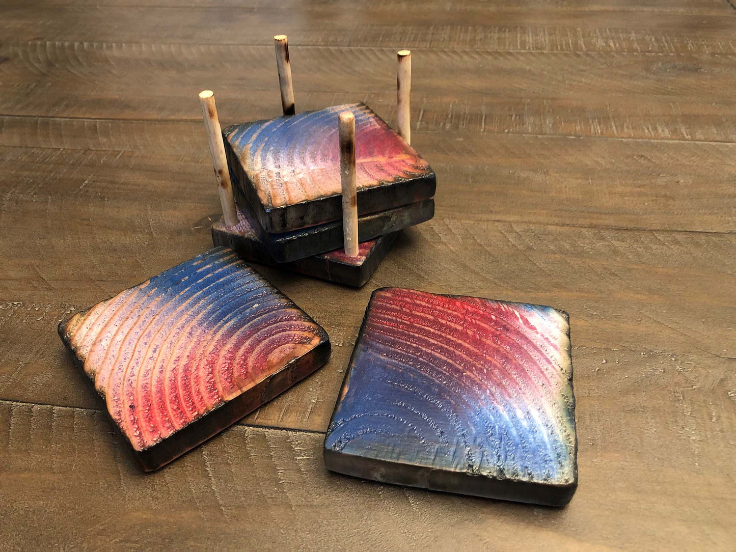 Rustic farmhouse wood coasters. Natural end grain pattern. Charred, burned and distressed. Patriotic red, white and blue distressed and burned. Set of 4 coasters and holder includes felt food pads. Handmade by Space Rubber Ducky Designs.