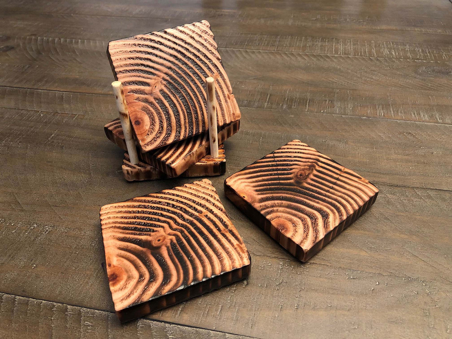 Rustic farmhouse wood coasters. Natural end grain pattern. Charred, burned and distressed. Patriotic red, white and blue distressed and burned. Set of 4 coasters and holder includes felt food pads. Handmade by Space Rubber Ducky Designs.
