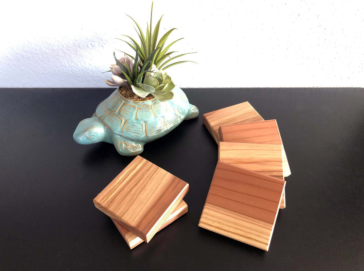 Reclaimed redwood coasters. Each coaster measures 3.5"x3.5" and feature felt feet to protect your table top. Finished with polyurethane for durability. Made in the USA.