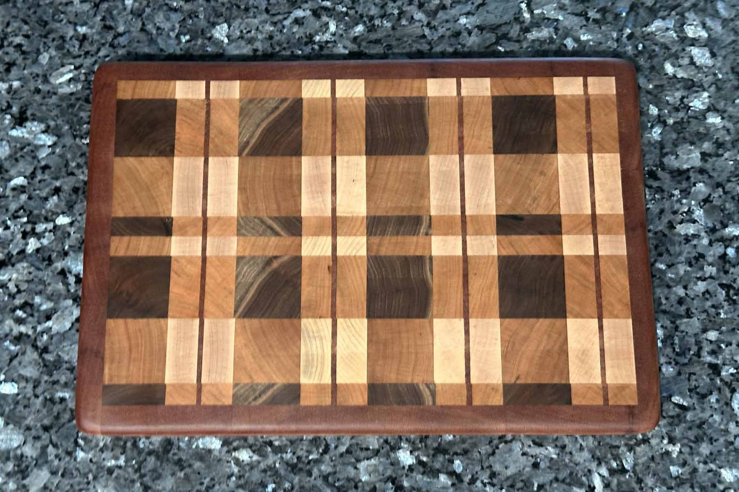 End grain cutting board with cherry, maple, black walnut, and mahogany hardwoods.