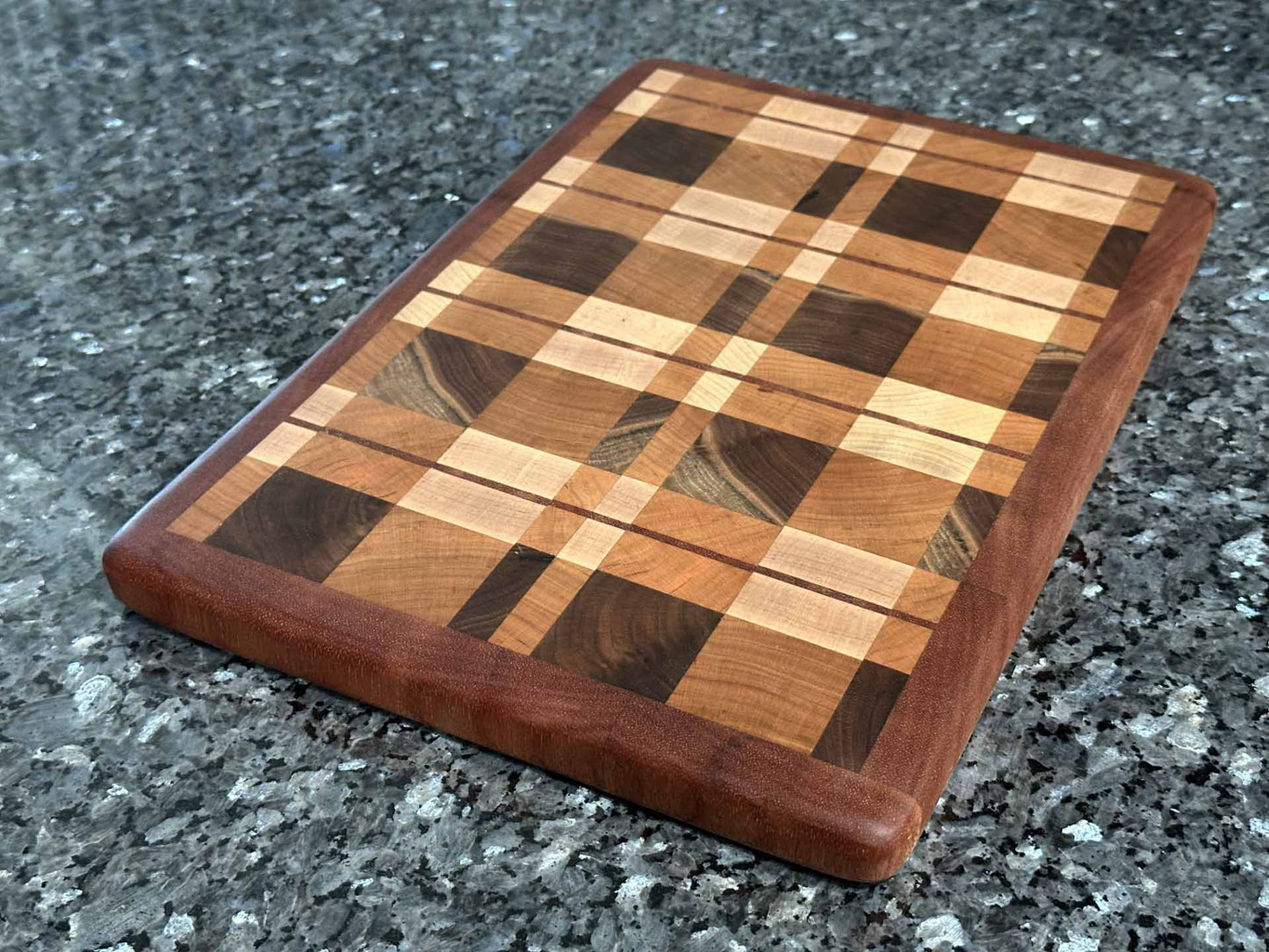 End grain cutting board with cherry, maple, black walnut, and mahogany hardwoods.