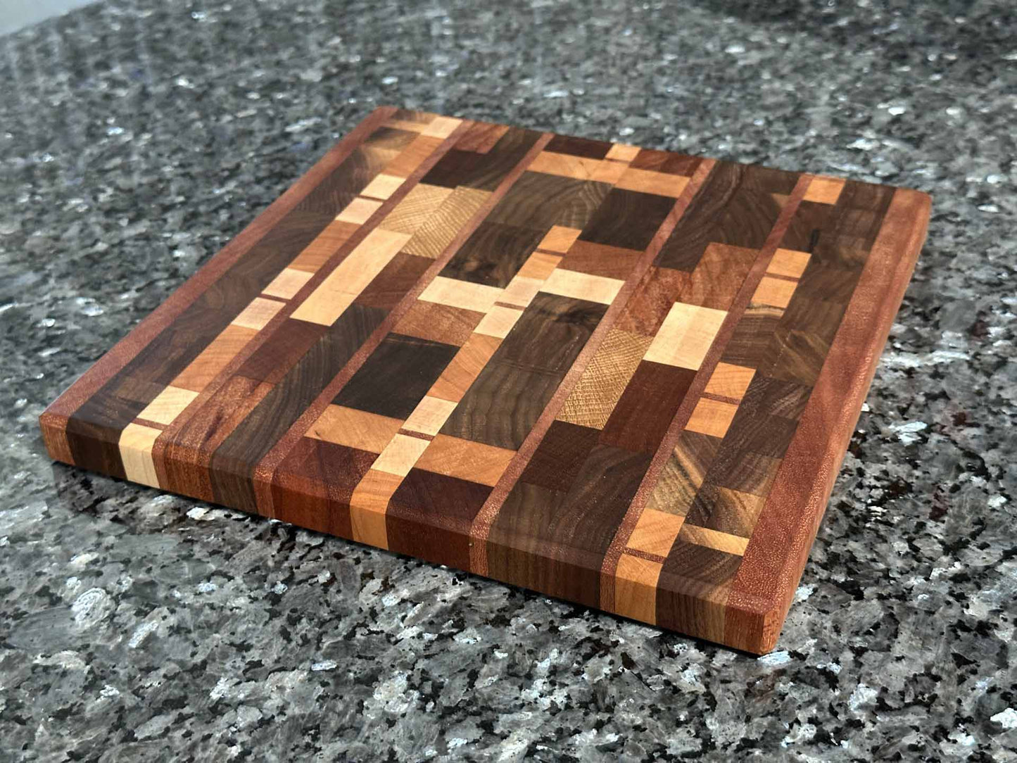 End grain cutting board with black walnut, mahogany, sapele, maple, cherry, and oak.