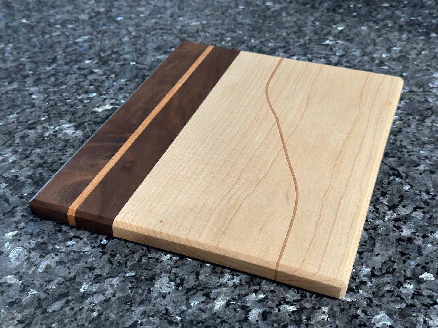 Long Grain Cutting Board with Black Walnut and Maple Hardwoods and Striking Cherry Accent by Space Rubber Ducky Designs.