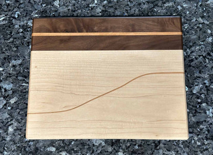 Long Grain Cutting Board with Black Walnut and Maple Hardwoods and Striking Cherry Accent by Space Rubber Ducky Designs.