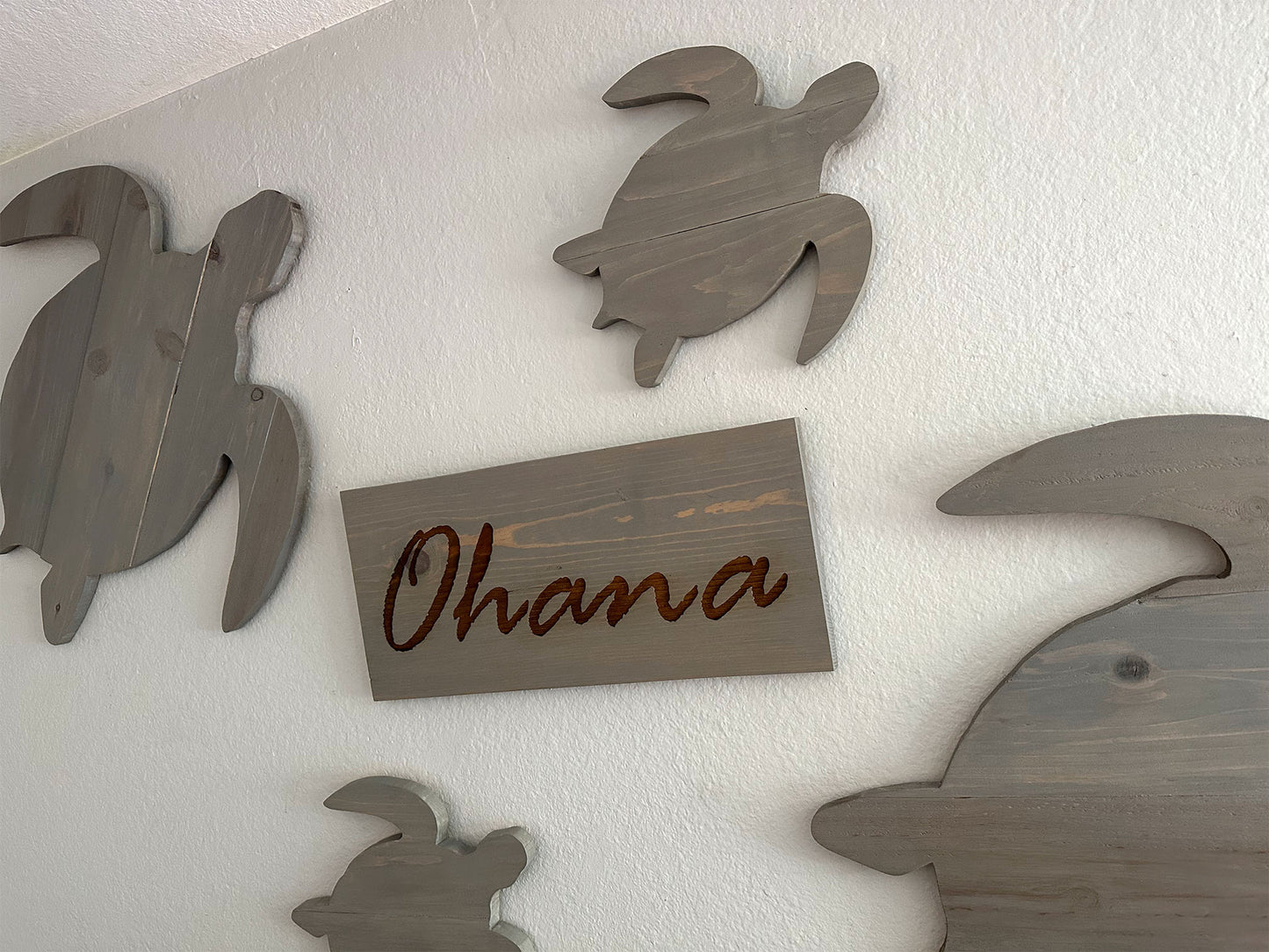 Custom handmade wood turtle wall art.  Set of 4 turtles includes a board with Ohana laser engraved.  Each piece includes mounting brackets and wall anchors.