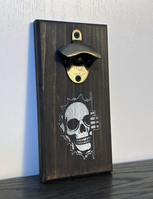 It's spooky season all year long with Mr. Bones peeking around the corner! Each custom magnetic bottle opener is handmade and has hidden rare earth magnets to catch metal bottle caps. Wall-mounted or magnetic backing options. Multiple wood stain choices. Made by Space Rubber Ducky Designs in Southern California, USA.