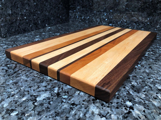Long grain cutting board. Features black walnut, maple, cherry hardwoods.