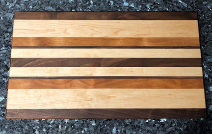 Long grain cutting board. Features black walnut, maple, cherry hardwoods.
