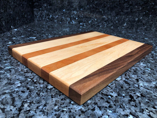 Long grain cutting board. Features black walnut, maple, cherry hardwoods.