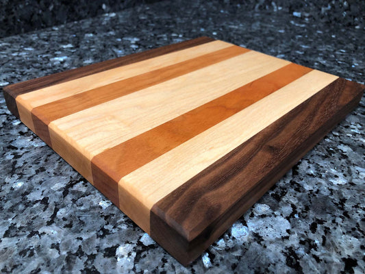 Long grain cutting board. Features black walnut, maple, cherry hardwoods.