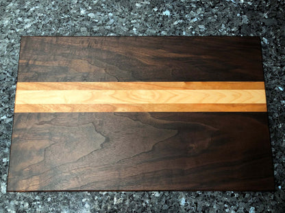 Long grain cutting board. Features black walnut, maple, cherry hardwoods. Chamfered edges and hard rubber feet for stability and air circulation.